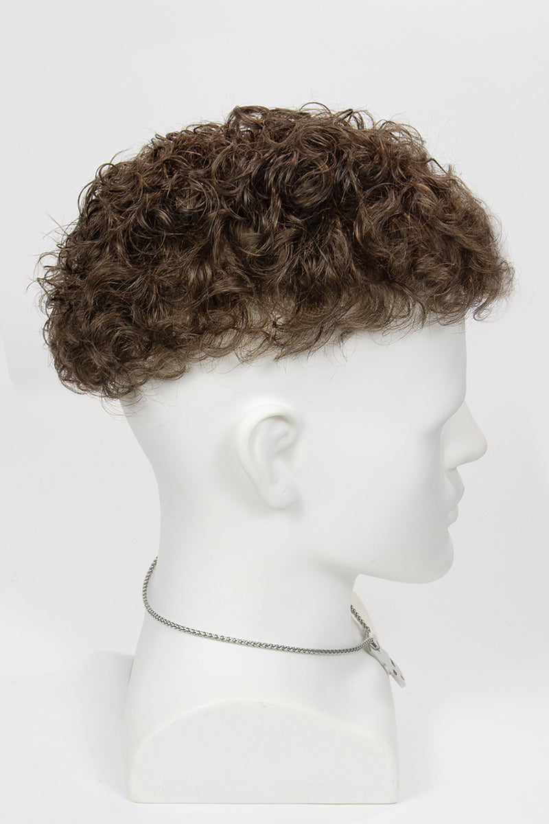 A mannequin head displaying a men's wig with curly hair.