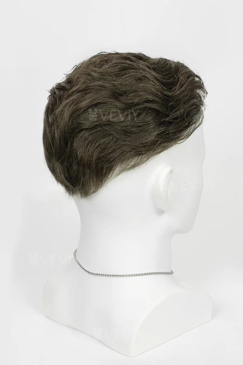 Man with styled hair and beard wearing a black turtleneck against a white background