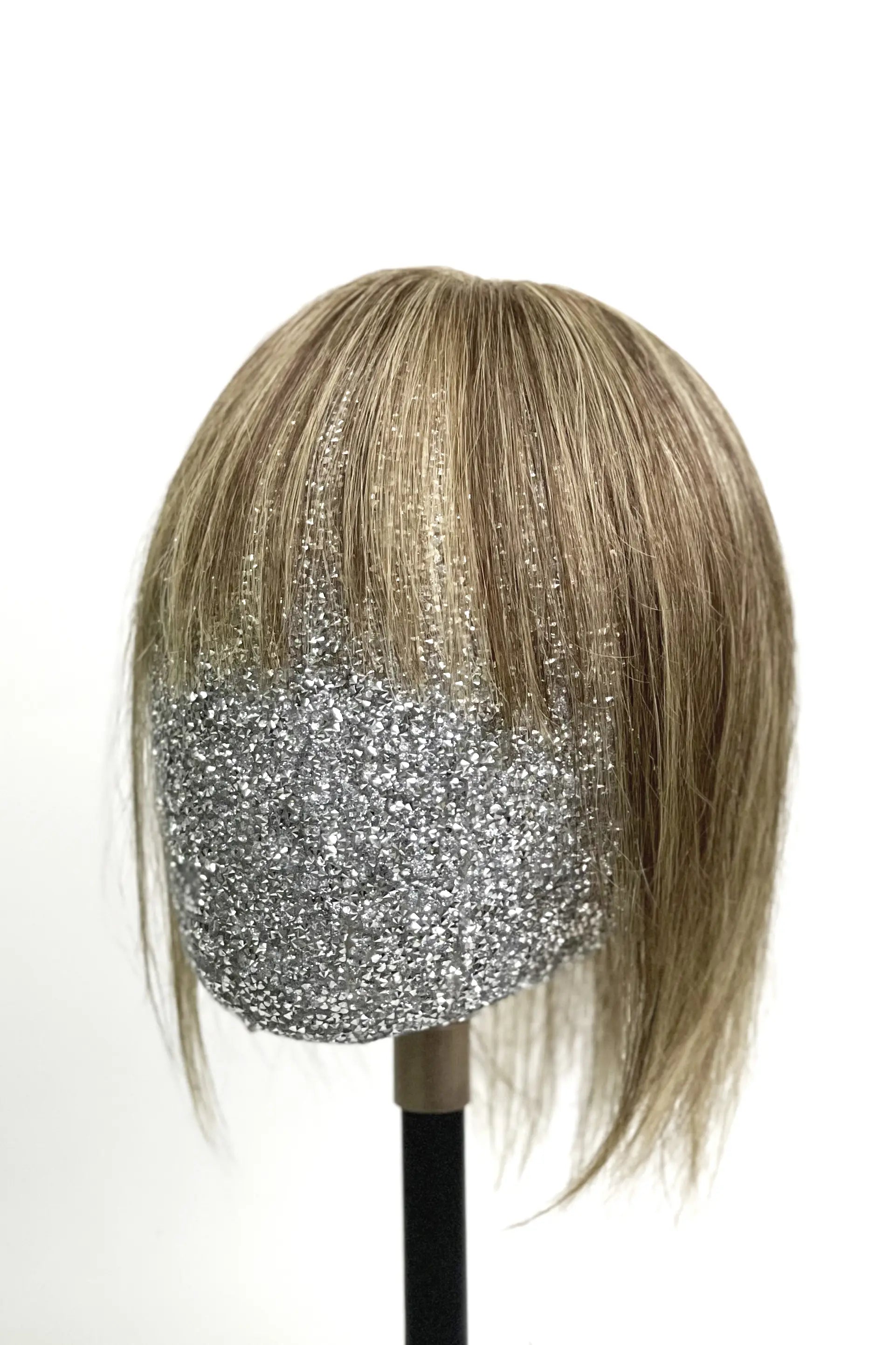A mannequin head showcasing Mona-B Handmade Human Hair Topper with Bangs Medium Brown with Warm Highlights #P4/27 with integrated hair bangs featuring warm highlights.