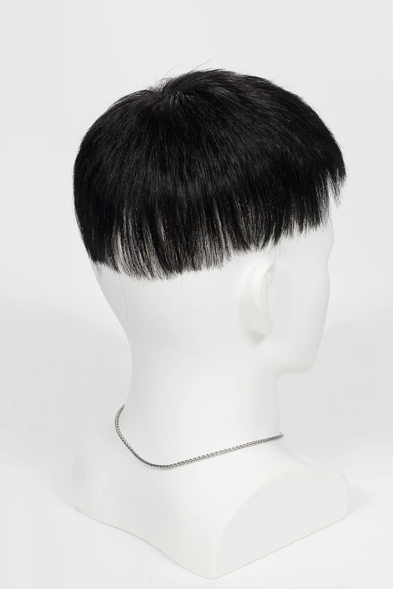 Man with styled hair and beard wearing a black turtleneck against a white background