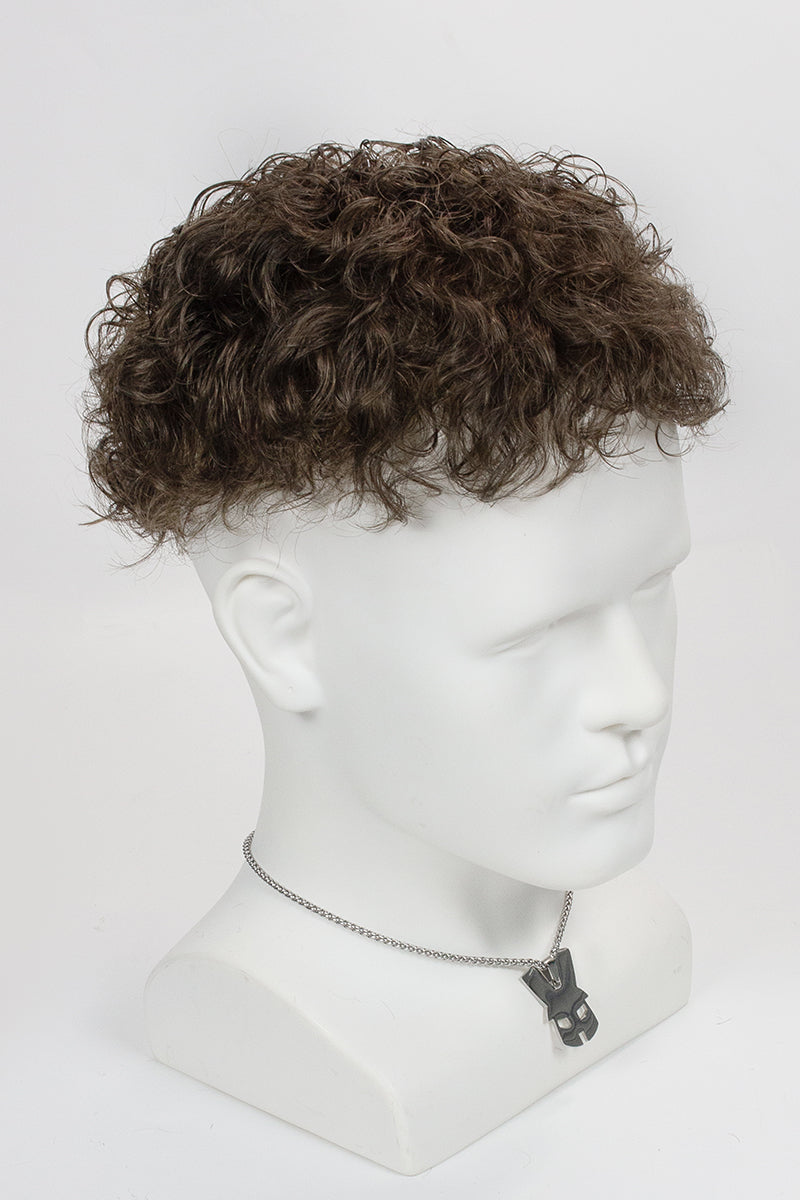 Mannequin head with a brown curly wig on a white background