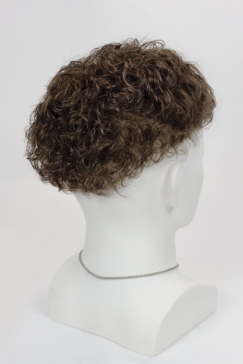 Curly wig on a mannequin head against a white background