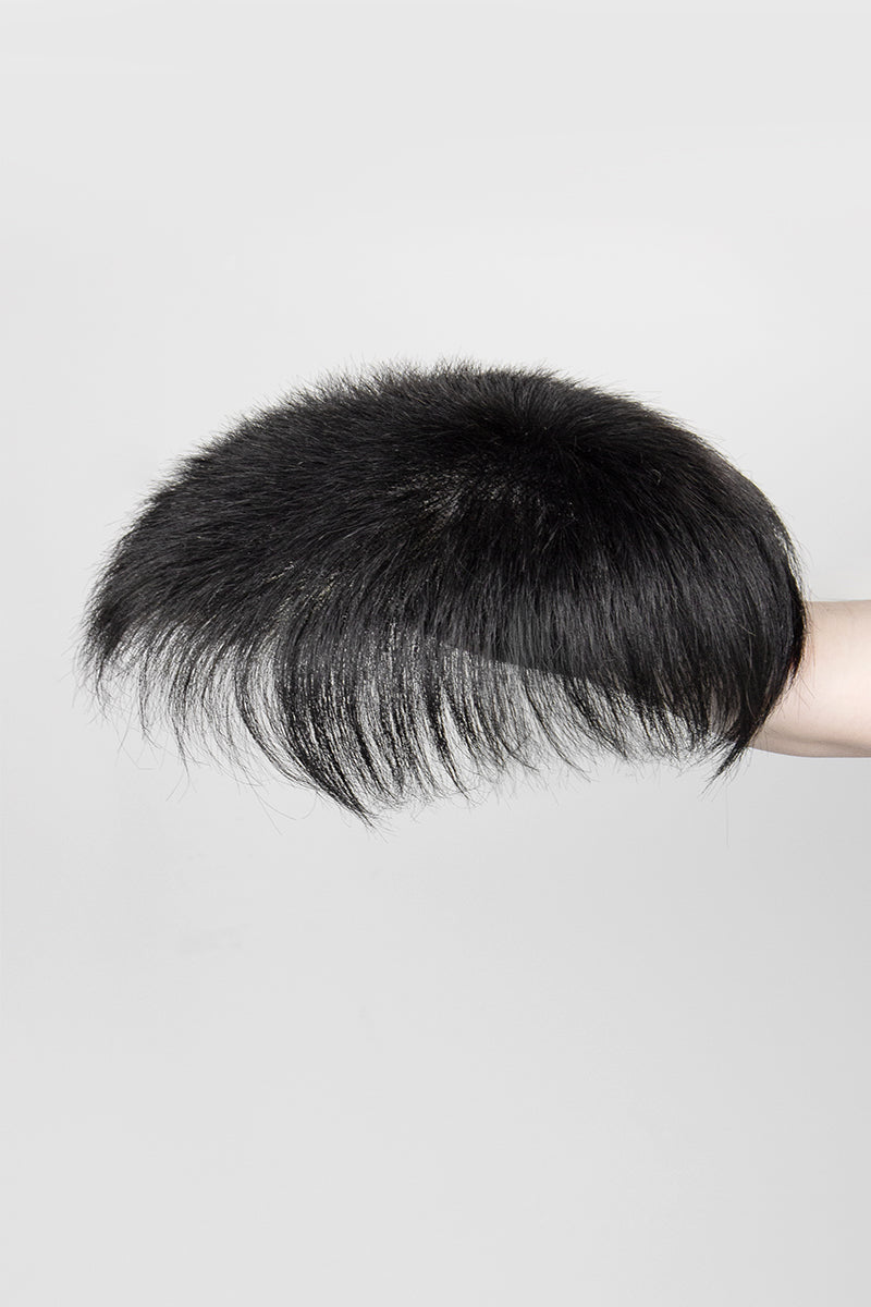 Black hairpiece on a gray background