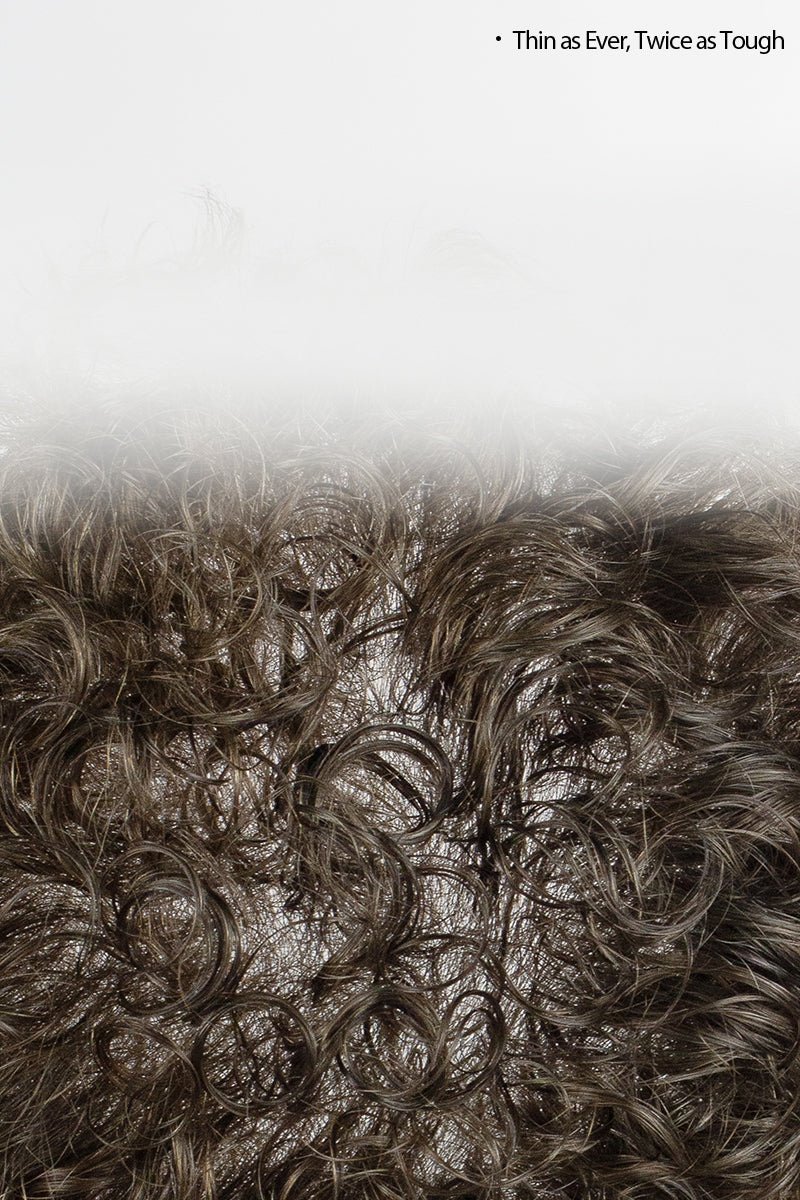 Close-up of textured brown material with a light gray background