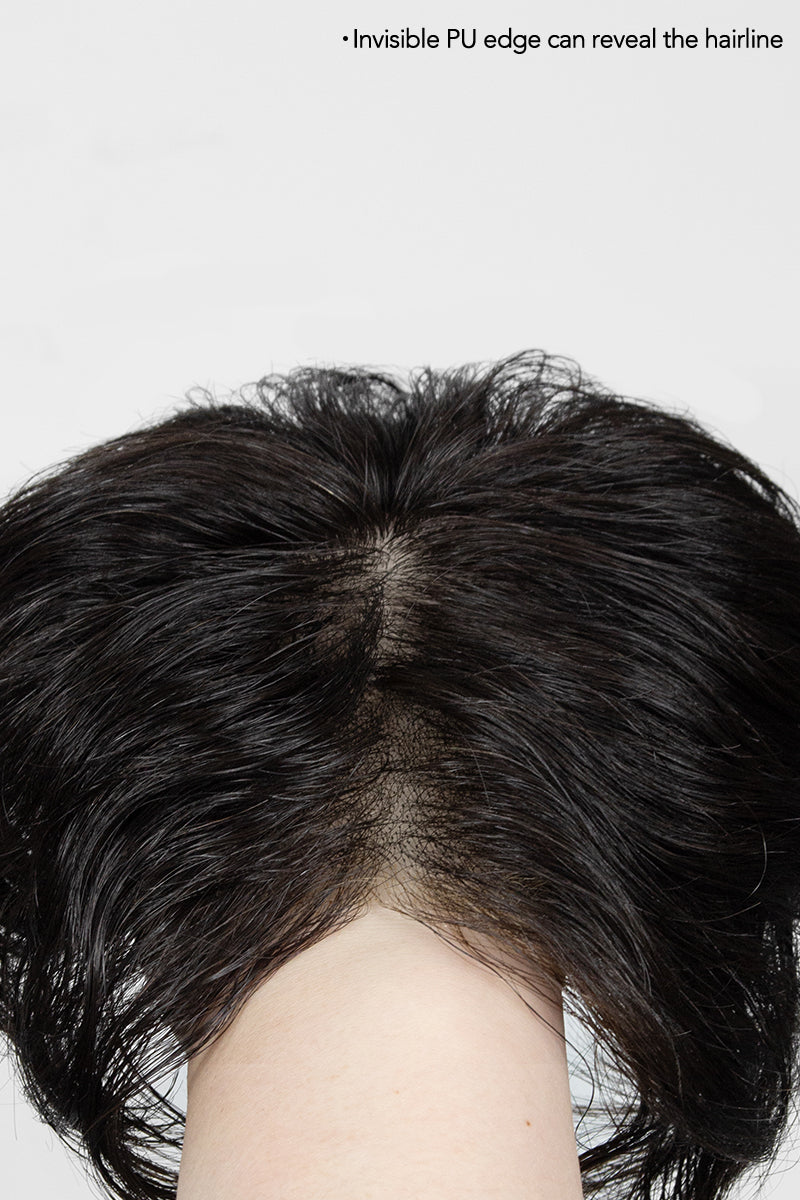 Close-up of a hair topper showing the hairline on a white background