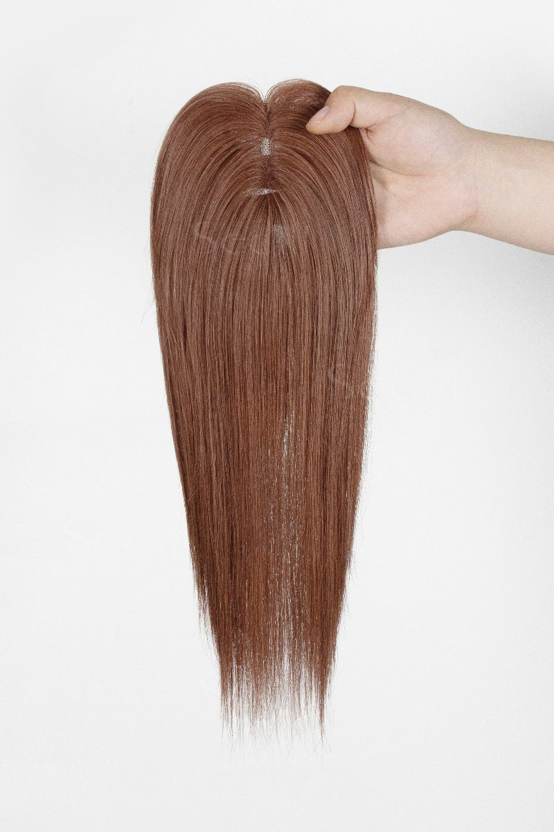 Mona Human Hair Topper Dark Auburn Brown #33 held by a hand on a white background