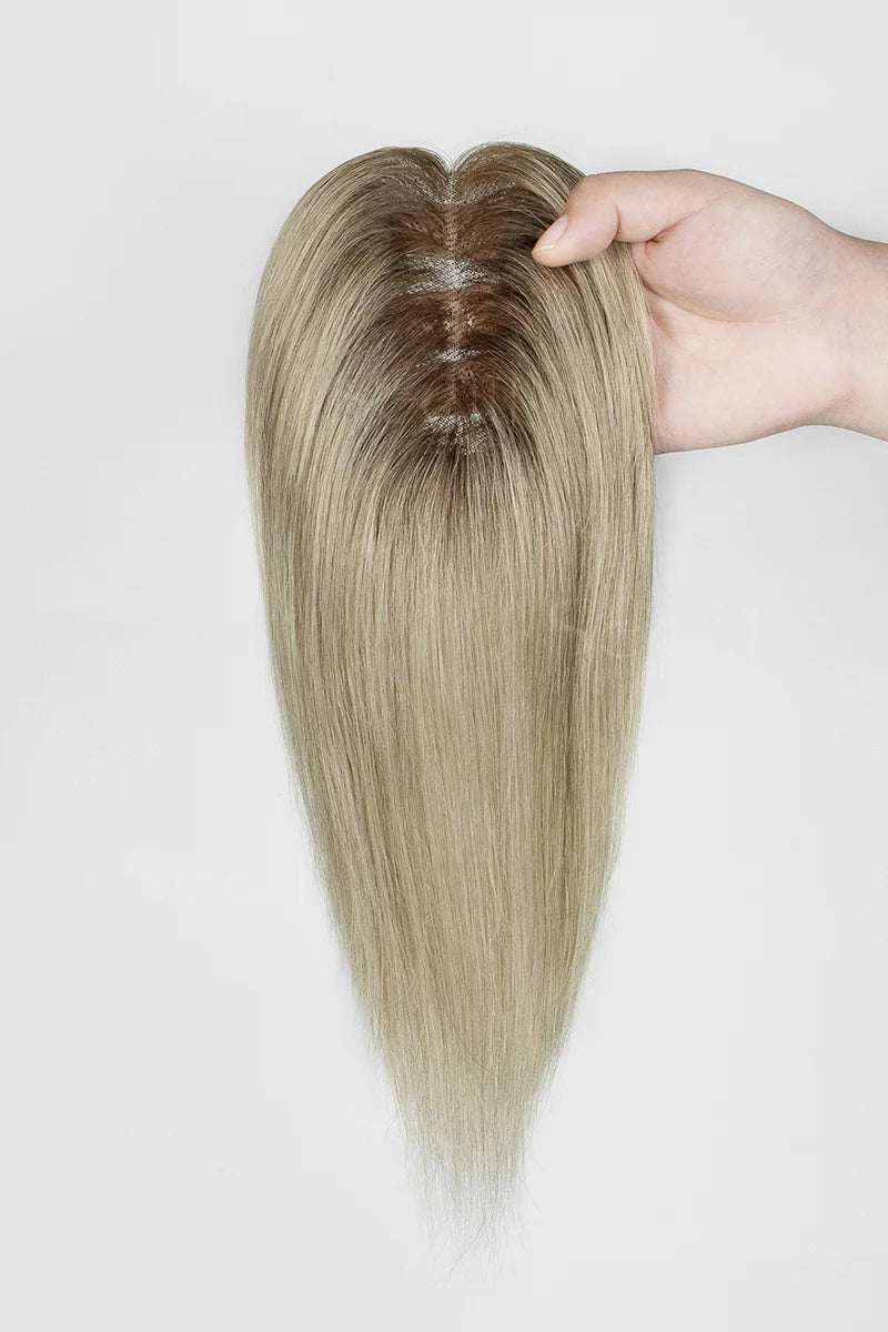 Mona Handmade Human Hair Topper Ombre Dark Root to Blonde #T2/M616 held by a hand on a white background